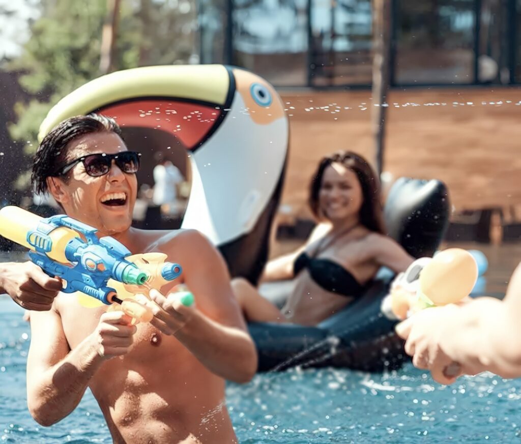 Friends playing with big water guns during a fun summer day.